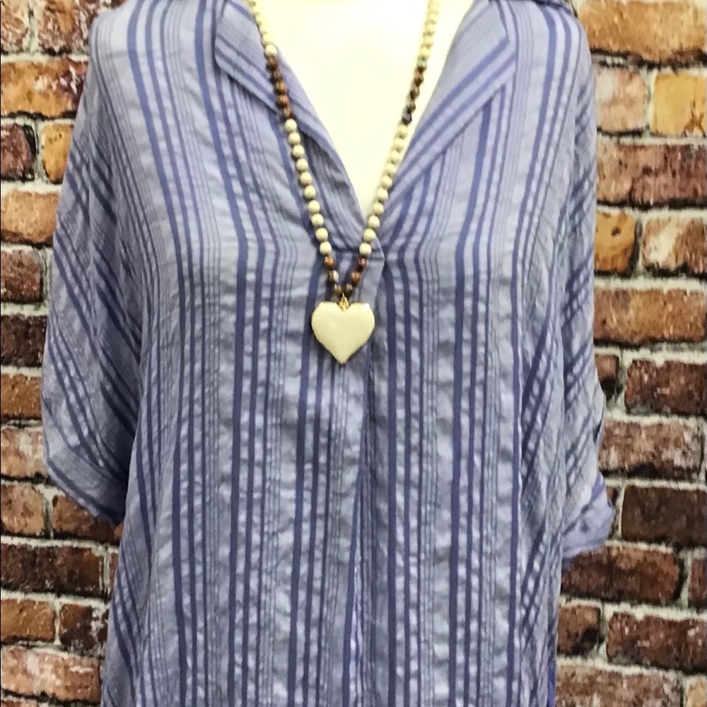Distressed collard v-neck top with button detail.